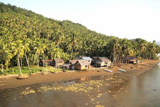 Riverside village, Carrascal, Surigao del Sur Nipa huts along the riverside can be seen from zip line in Carrascal, Surigao del Sur, Philippines. 