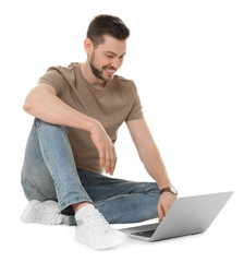 Handsome young man with laptop on white background