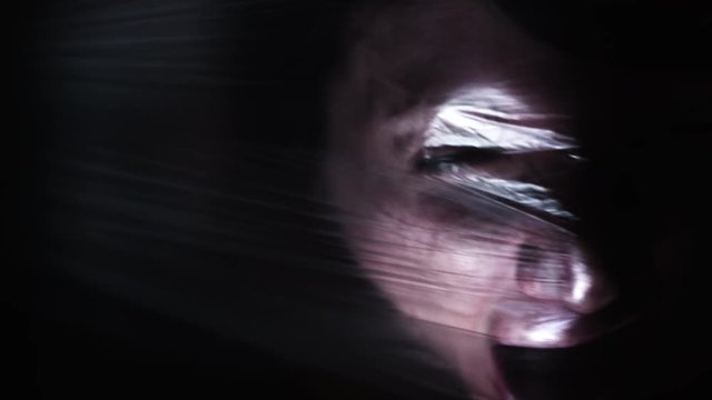 4K Horror Shot Of Woman Trying to Breath in Plastic Bag