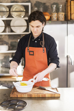 Sweden, Vastmanland, Man preparing food