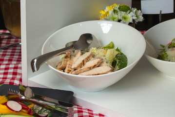salad with Chicken in the white bowl