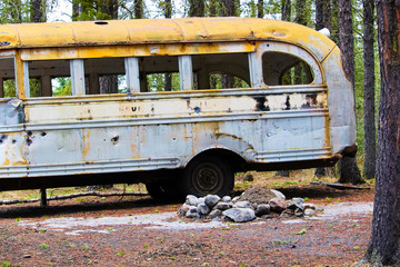 Stripped abandoned bus at a hunters camp on crown land
