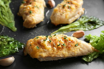 Roasted chicken breasts with lettuce on baking tray, closeup