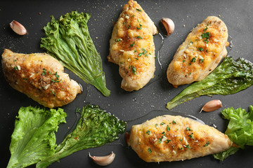 Roasted chicken breasts with lettuce on baking tray, closeup