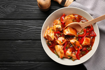 Plate with chicken cacciatore on kitchen table