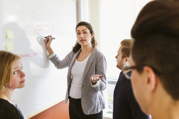 Sweden, People sharing ideas during work meeting