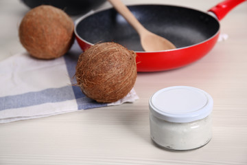 Jar with coconut oil on table