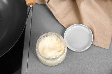 Jar with coconut oil on table