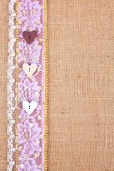 background - natural color burlap hessian with lace and button border
