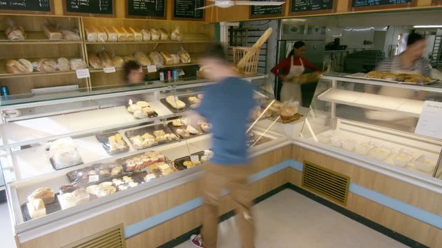  Time lapse workers & customers in busy bakery shop