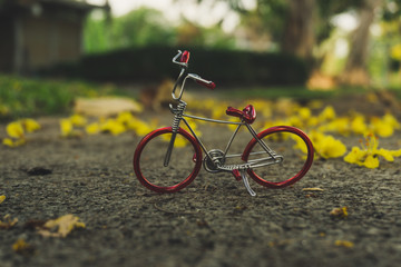 Fototapeta na wymiar Red bicycle on beautiful yellow flower background.