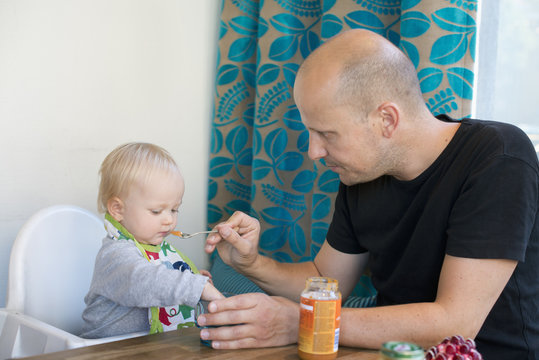 Sweden, Father feeding baby son (12-17 months)