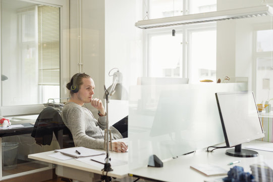 Sweden, Young Man Working In Office