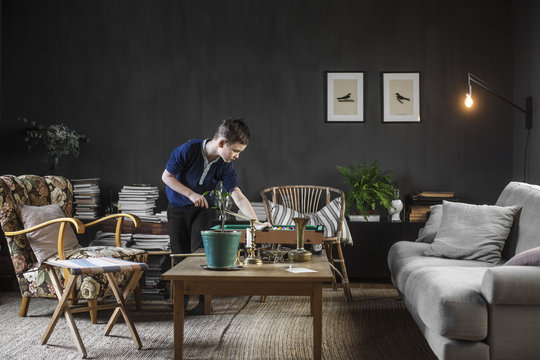 Sweden, Boy (8-9) playing mini billiard in living room