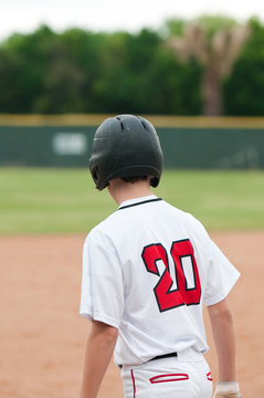 Teenage Baseball Boy Ready To Steal Base.