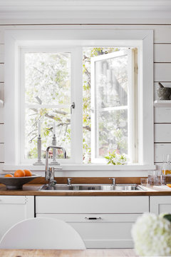 Sweden, Sink by white window in domestic kitchen