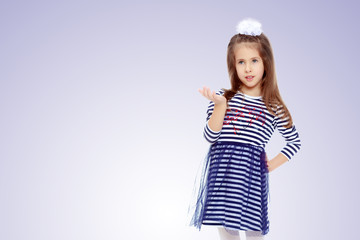 Cute little girl posing in front of the camera.