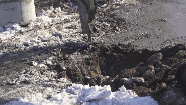 Breaker (hydraulic) cuts frozen soil stock footage video