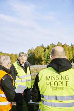 Sweden, Uppland, Rison, Volunteers helping emergency services find missing people