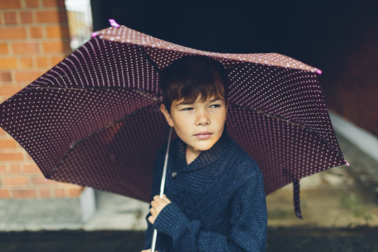 Sweden, Blekinge, Karlskrona, Portrait of boy (8-9) holding umbrella