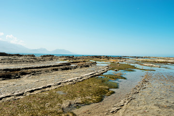 empty rocky beach in blue sky