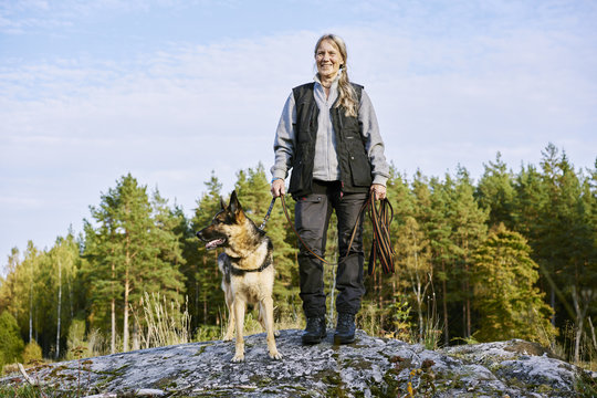 Sweden, Uppland, Rison, Portrait of volunteer with dog helping emergency services find missing people