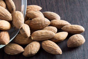 roasted almonds pouring out of the glass bowl