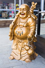 Fototapeta na wymiar Smiling Buddha - Chinese God of Happiness, Wealth and Lucky on background