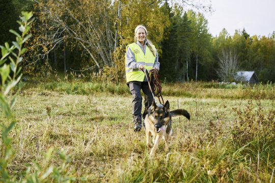 Sweden, Uppland, Rison, Portrait of volunteer with dog helping emergency services find missing people