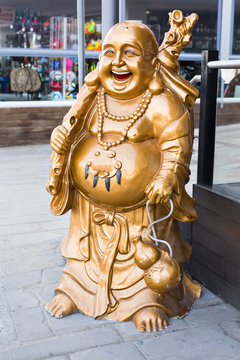 Smiling Buddha - Chinese God of Happiness, Wealth and Lucky on background
