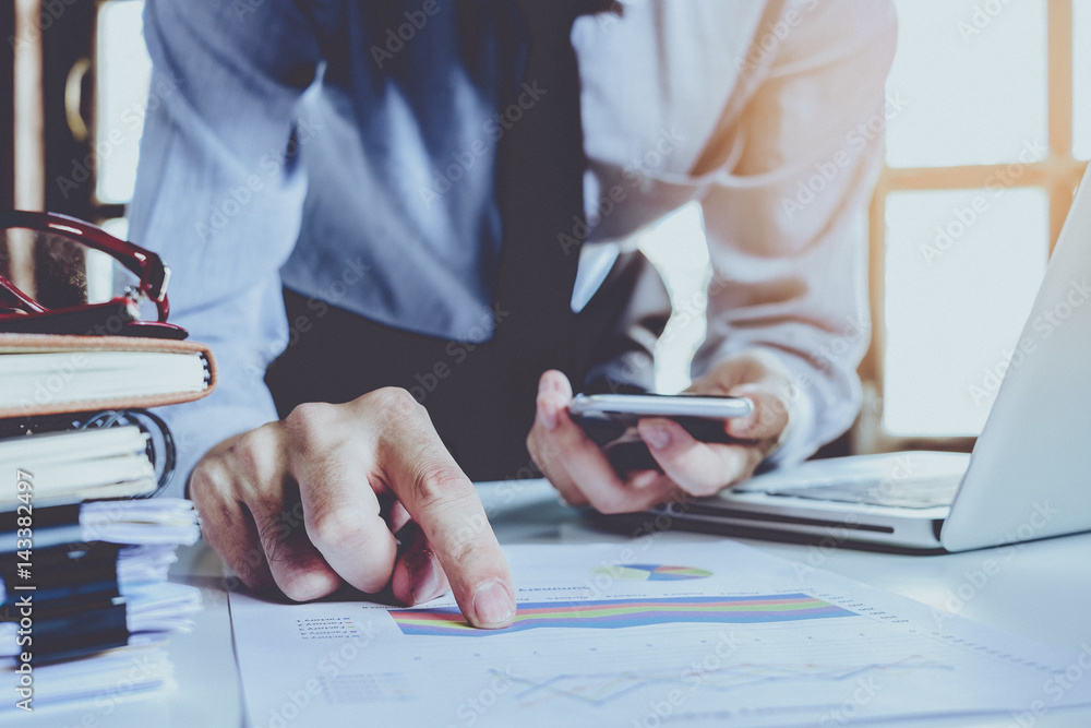 Aufkleber businessman hand working with business graph or analysis chart and using smart phone .close up with 