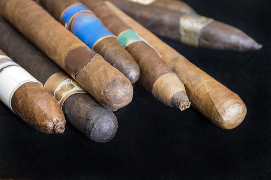 group of cigars on black background