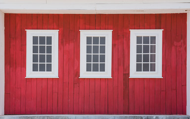 White window with red wood wall .