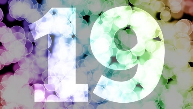 Nineteen to twenty years birthday fade in/out animation with color gradient moving bokeh background. Animation: 90 frames still with number, 180 fade out, 30 clear, 180 fade in, 300 still.