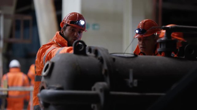 Engineer in power station carrying out maintenance & checking the machinery