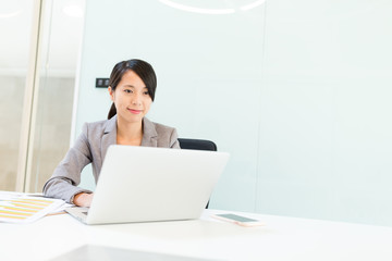 Businesswoman working on laptop computer