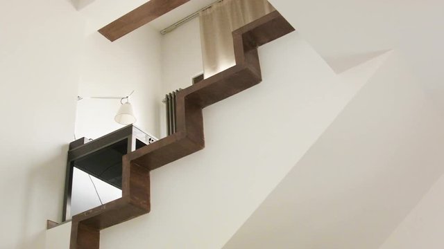 Staircase with table and lamp upstairs, indoor cropped image