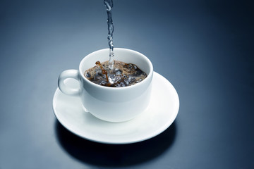 boiled water from the kettle is poured into a white Cup for coffee