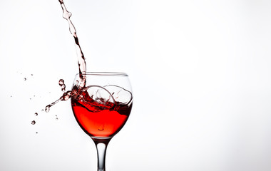 A glass with pink wine and sprays.