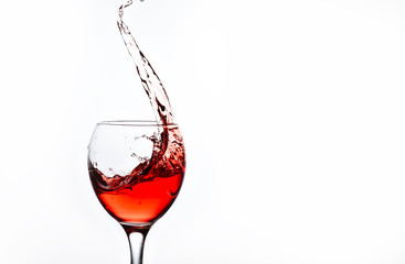 A glass with pink wine and sprays.