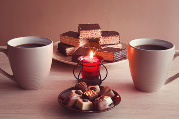 Enjoying coffee and sweets by candlelight and lovely conversations in the romantic evening atmosphere.