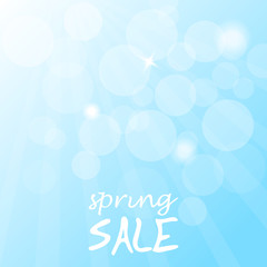 Naklejka na ściany i meble Spring sale on a blue blurred background.