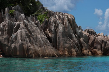 Fototapeta na wymiar Granite Rocks of St. Pierre Island close Praslin Island, Seychelles / Beautiful scenery with blue Indian Ocean and red granite rocks.