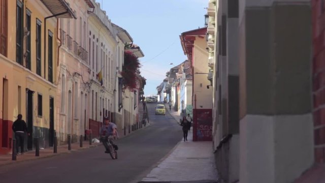 Man riding bike in the street among Candelaria's colonial buildings Full HD