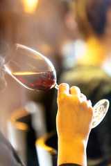 Girl drinks glass of red wine.