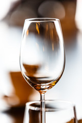 Empty wine glass standing on the table .