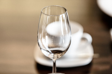 Empty wine glass standing on the table .