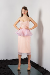 Fototapeta premium Attractive fashion model in festive dress with lace Basque posing