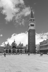 Beautiful black and white vertical view of Piazza San Marco square in a moment of tranquility on a sunny summer day, with a picturesque sky, Venice, Italy