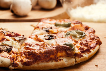 Slices of pizza with bacon, olives and jalapeno papper